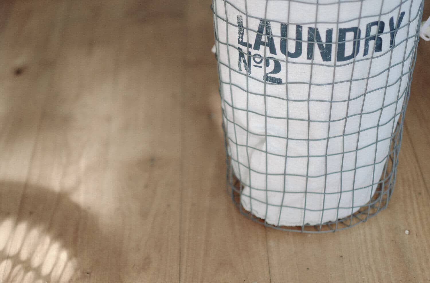An empty white laundry basket.